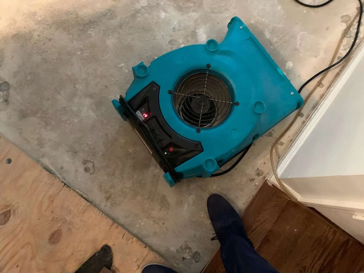 Air mover drying subfloor during Commercial Water Damage Restoration in Battle Creek